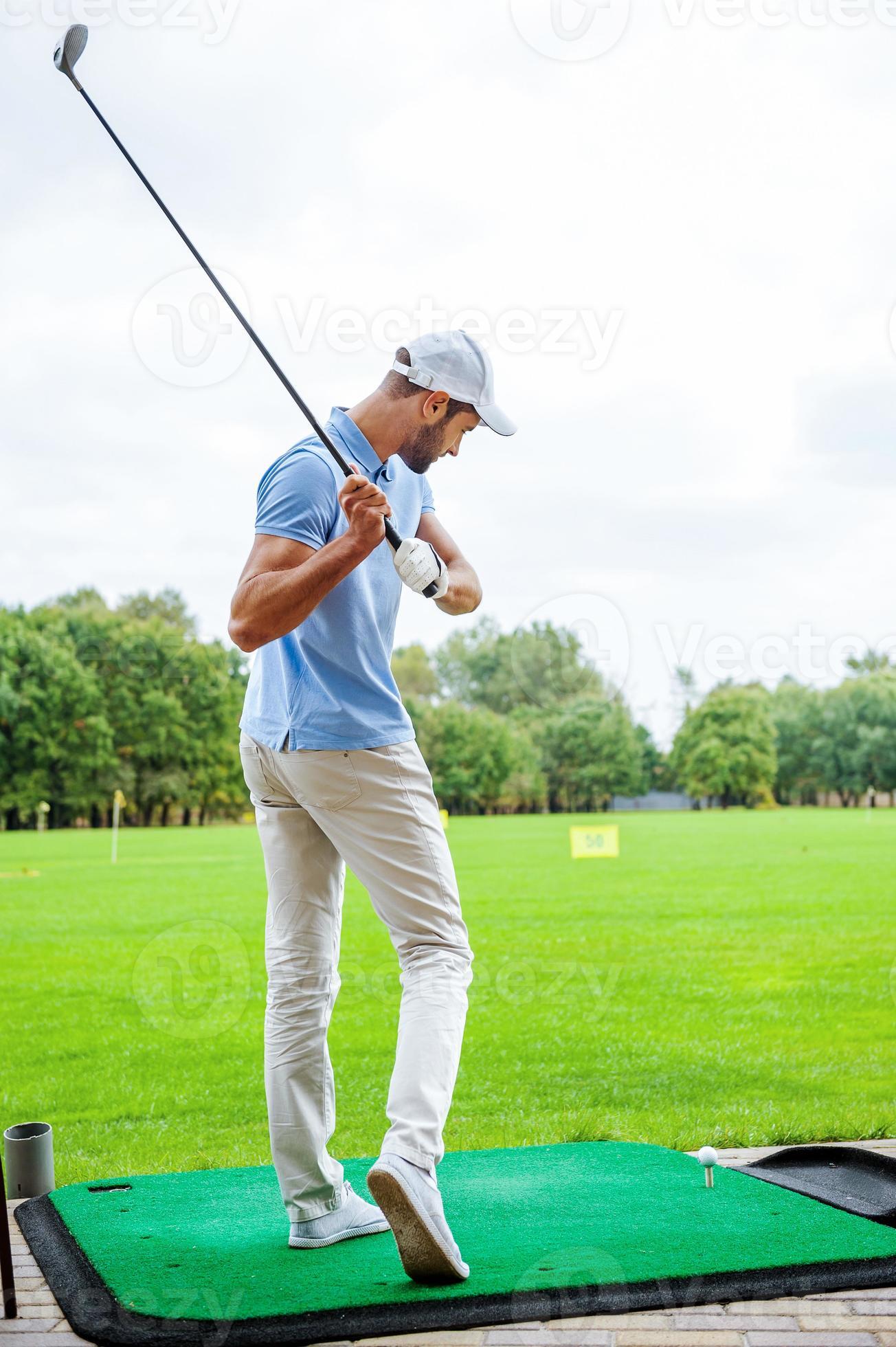 teeing-off-full-length-rear-view-of-young-male-golfer-playing-golf-photo.jpeg