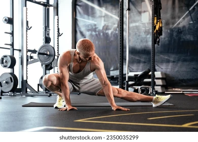 man-gym-doing-stretching-exercises-260nw-2350035299.webp